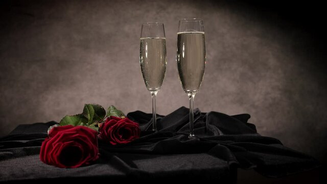 Champagne and red roses in close-up view - studio photography