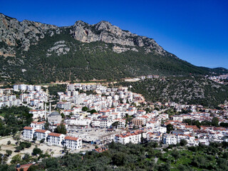 Naklejka premium The top view from the drone of Kas resorts and city with amazing blue and clear lagoon and yachts in Mugla province of Turkey
