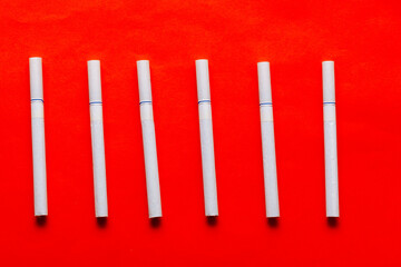 White cigarettes at red background .  Nicotine in Tobacco 
