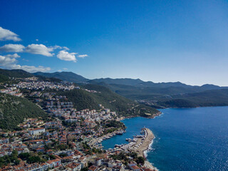 Fototapeta na wymiar The top view from the drone of Kas resorts and city with amazing blue and clear lagoon and yachts in Mugla province of Turkey