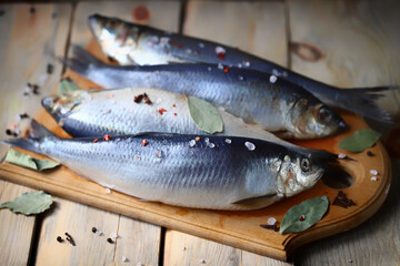 Selective focus. Spicy salted herring. Whole salted herring. Norwegian herring. Saltwater fish omega 3.