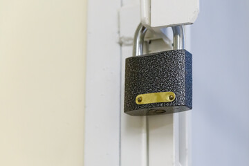 dark iron padlock close-up on the background of an iron lattice