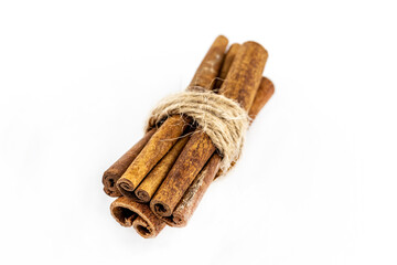 cinnamon pod set tied with a rope on a white background