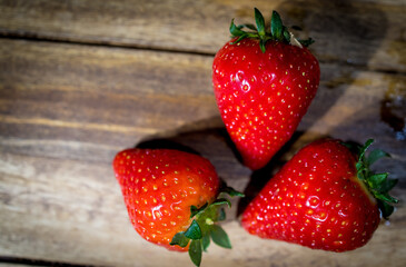 Strawberries on a wooden table in close-up - studio photography