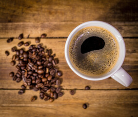 Freshly brewed cup of coffee on a wooden table - studio photography