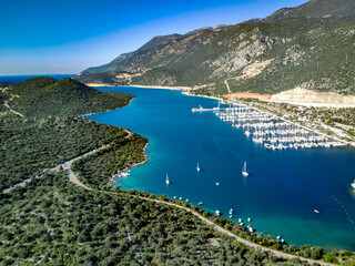 Fototapeta na wymiar The top view from the drone of Kas resorts and city with amazing blue and clear lagoon and yachts in Mugla province of Turkey