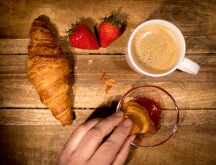 Eating freshly baked French croissants for breakfast - studio photography