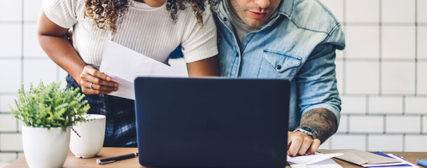 Happy smiling couple working with laptop computer together .creative business couple planning and brainstorm in living room at home
