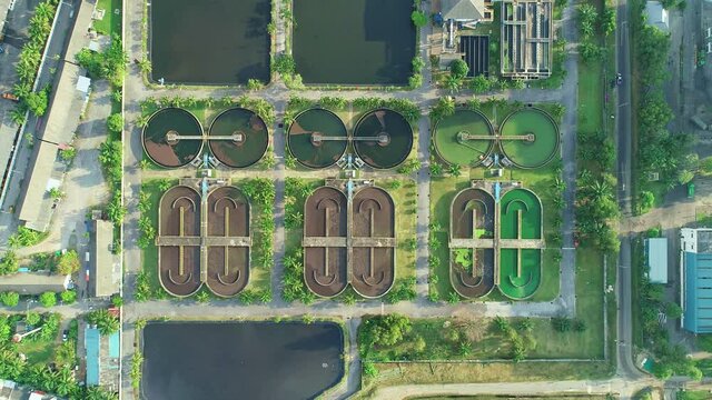 Aerial view High angle view Top down drone shot of the sewage treatment plant.The Solid contact clarifier tank type sludge recirculation in water treatment plant. Industrial wastewater treatment plant