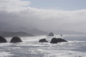 Fototapeta na wymiar Cannon Beach and Haystack Rocks on the Oregon Coast as Seen from Ecola State Park, Taken in Sping