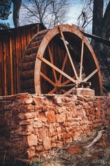 Obraz premium wooden water wheel and stone
