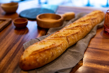 pain baguette sur un comptoir en bois avec un tissus dessous