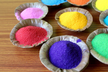 Indian Holi  traditional colors in disposal organic bowl, different organic Gulal color on the occasion of Holi festival, Abstract background, selective focus with blur.
