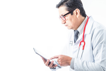 Doctor in a gown, stethoscope and tie reviewing information or diagnosis on a tablet. Medicine and technology concept