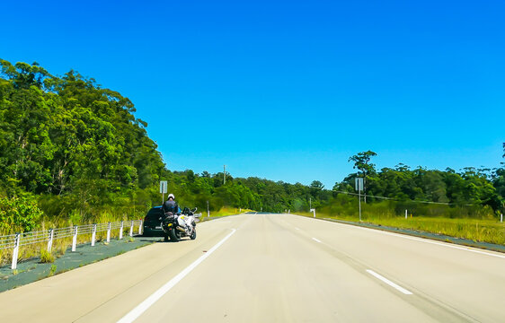 Motorcycle Highway Patrol officer checking a car and its driver on the Pacific Highway on the east coast of Australia