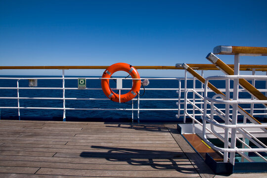 Deck of cruise ship and life ring on railings