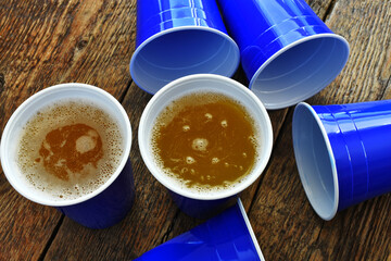 A top view image of several blue plastic drinking cups ready to use for a game of beer pong. 