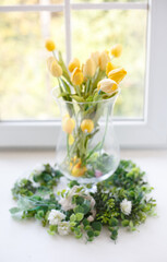 Bouquet of yellow tulips on the window. Beautiful and comfort morning. Sunny day. Decoration of home interior