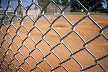 baseball and softball field behind fence