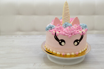 birthday cake in the form of a multi colored unicorn. Sweet cute cake