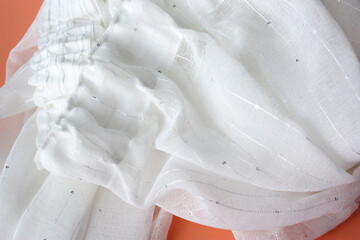 Obraz na płótnie Canvas White transparent curtain on a pink background. Soft folds of fabric as a background.
