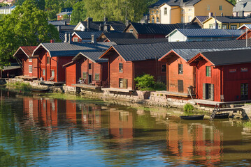 Fototapeta na wymiar Old red barns on the Porvoonjoki river on a sunny July day. Porvoo city symbol, Finland