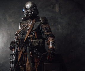 Military survivor with shield and gas mask in dark background