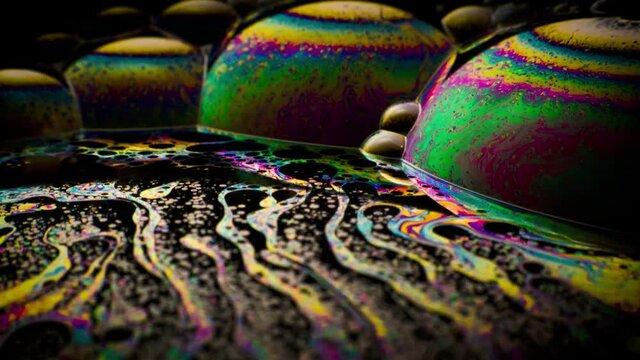 Colorful close-up surface of a soap bubble with abstract psychedelic background and patterns.
Vivid rainbow colors in weird and strange patterns. 
