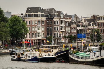 Canals of the Amsterdam city in Amsterdam, Netherlands. The historical canals of the city surrounded by traditional dutch houses is main attractions of Amsterdam.