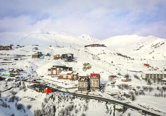 Fototapeta na wymiar Gudauri village panorama with ski resort background from aerial perspective