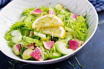 Salad from watermelon radish, cucumber, celery and lettuce leaves. Vegan food. Dietary menu.