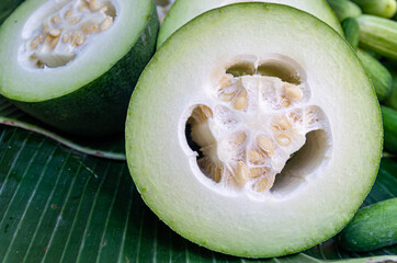 Close-up view of a cut winter melon (benincasa hispida) on banana leaf - selected focus - text space