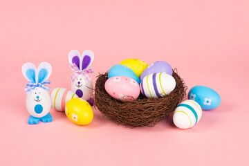 Colorful Easter eggs rabbit isolated on pink background