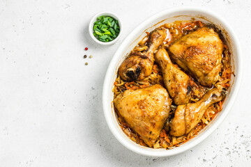 Roasted garlic chicken and vegetables in baking dish. Space for text, top view.