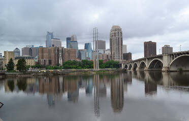 Obraz na płótnie Canvas Minneapolis downtown skyline and Third Avenue Bridge above Mississippi river. Midwest USA Minnesota state.