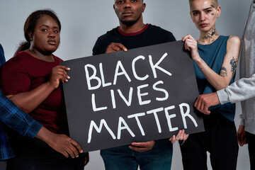 Black Lives Matter placard in multiracial people hands