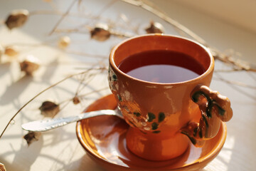 cup of black tea with lemon slice at early morning