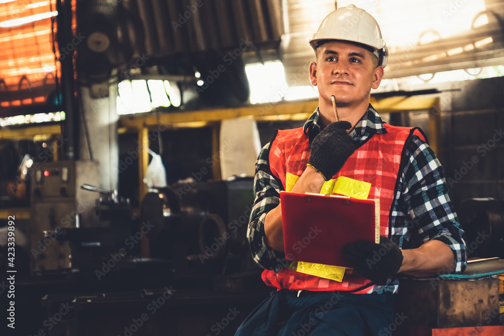 Poster manufacturing worker working with clipboard to do job procedure checklist . factory production line 