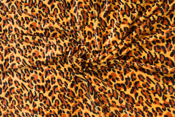 Colored brown textile satin fabric folded in folds and waves with highlights and texture