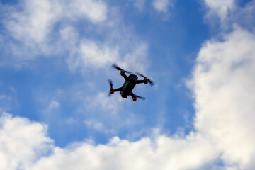Drone fly with the blue sky and white clouds.