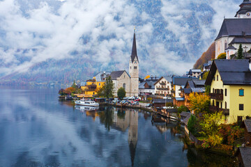 Fototapeta premium Hallstatt town view in a foggy day and clouds between the mountains, Austria.