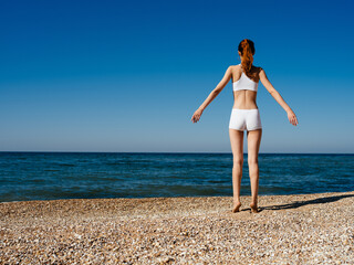 Woman on the beach white swimsuit landscape tropics vacation