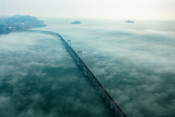 Aerial landmark bridge across the sea in the fog in Dalian, Liaoning Province, China
