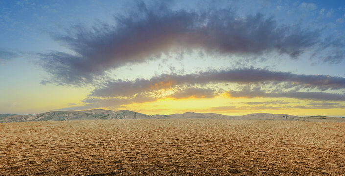 sunset in desert landscape, dry soil background