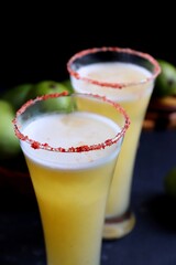 Indian traditional sweet green mango juice. Also known as Aam Panna, Ambyache Panha. Summer Refreshing drink made with raw mangos, jaggery, and salt. Recipe ingredients with copy space.