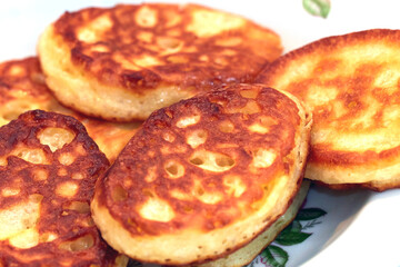 Fried hot pancakes in a white plateA
