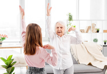 Granmother and granddaughter exercising