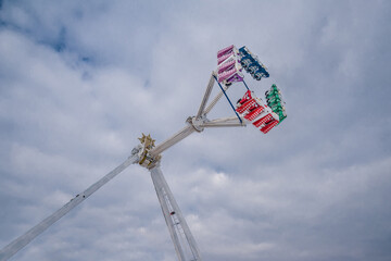 Spinning attraction against the sky