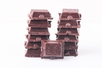 Broken dark chocolate broken stack isolated on white background