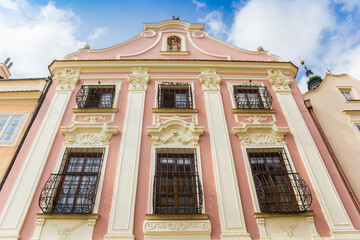 Fototapeta na wymiar Facade of a pink historic building in Mikulov, Czech Republic